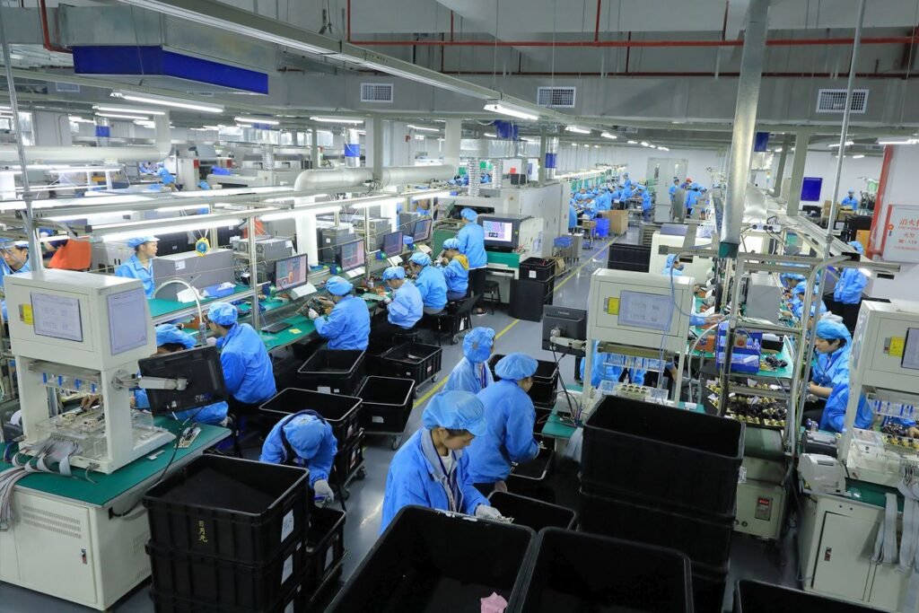 Voltronic Power factory workers operating advanced production equipment